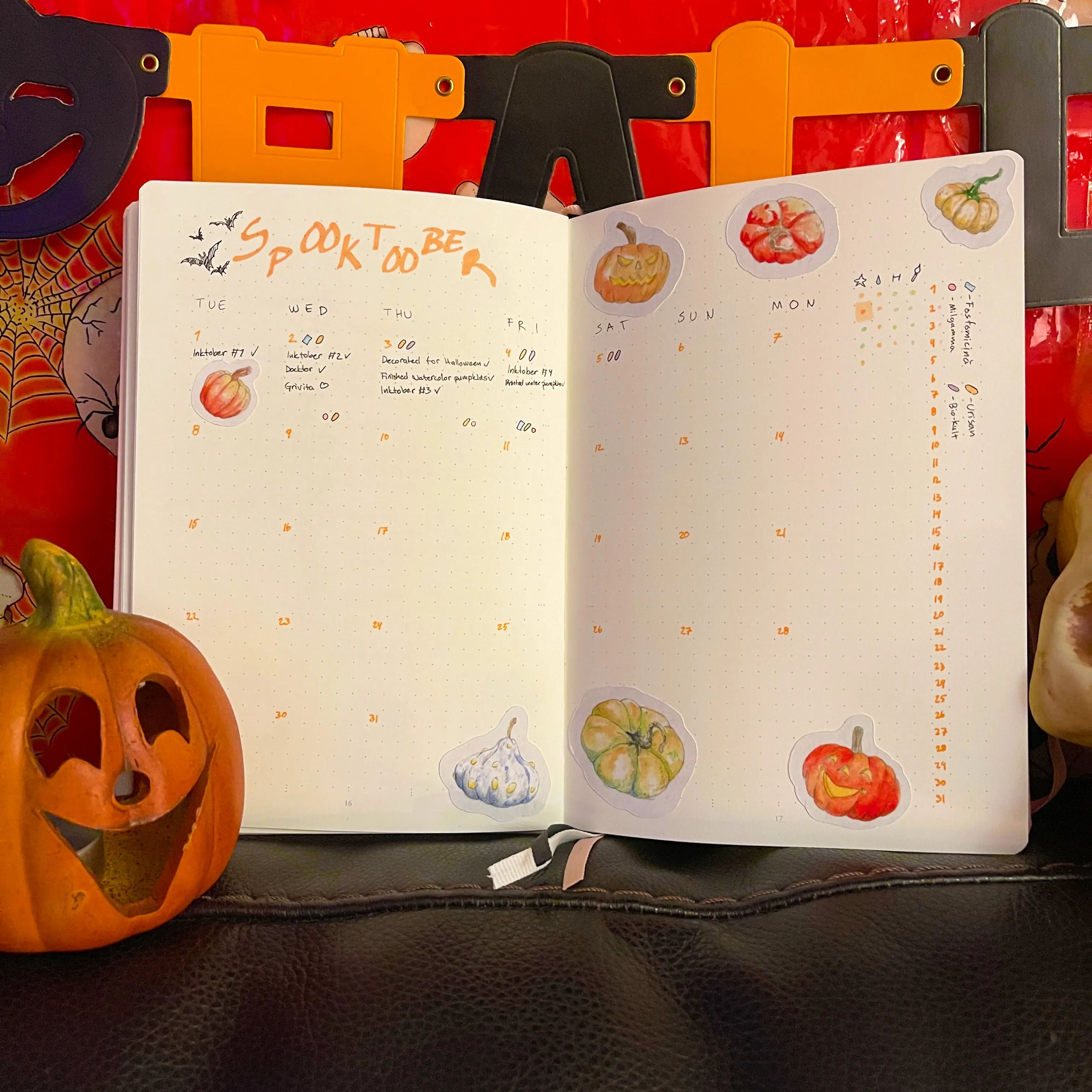 Die-cut watercolor stickers of pumpkins stuck on a journal.